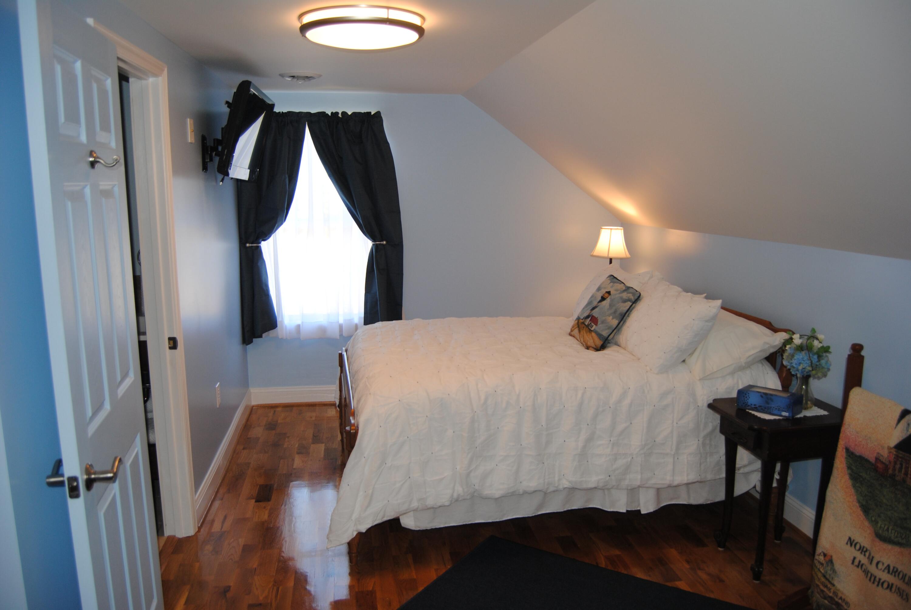 60 Tara Drive Ridgeway, VA 24148 - Photo 25 of 93 a bedroom with a bed and chair