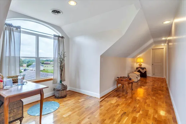 a view of a lush green forest with trees and houses