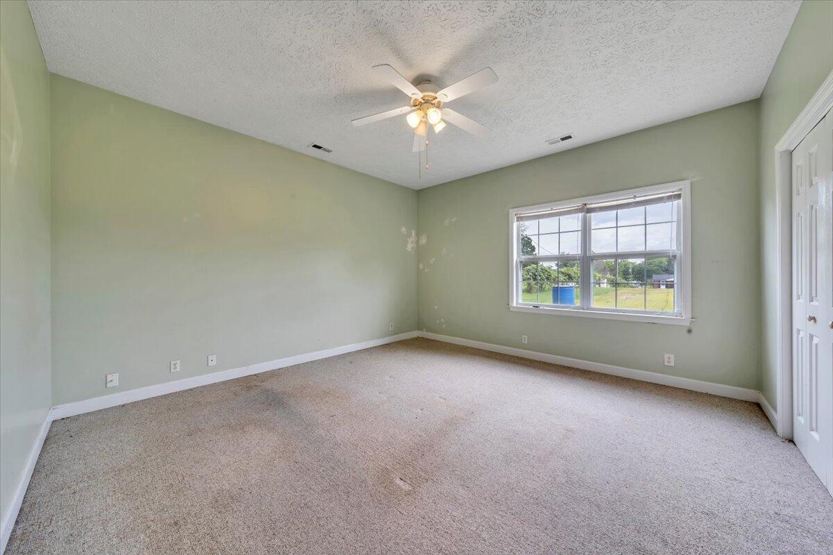 60 Tara Drive Ridgeway, VA 24148 - Photo 49 of 93 an empty room with windows and ceiling fan