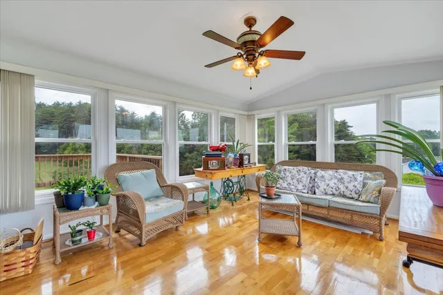 a view of a livingroom with a ceiling fan and window