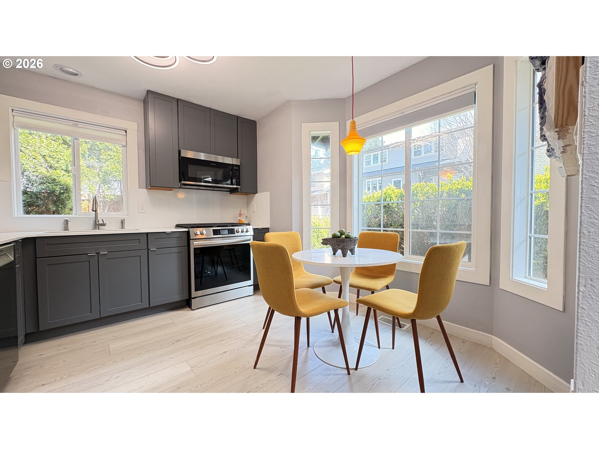 6650 Southwest Canby Street Portland, OR 97223 - Photo 5 of 34 a kitchen with a table chairs in it and wooden floors