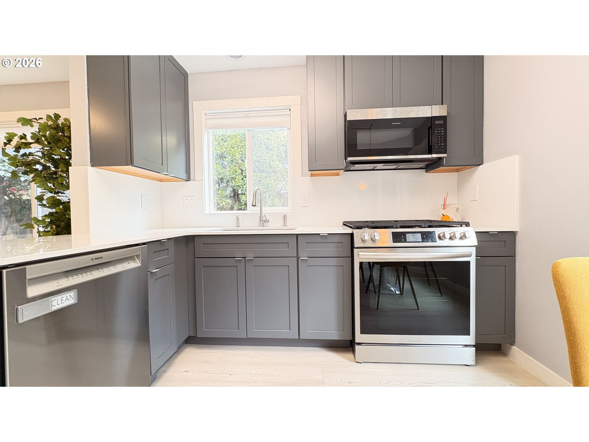 6650 Southwest Canby Street Portland, OR 97223 - Photo 6 of 34 a kitchen with a sink and a microwave