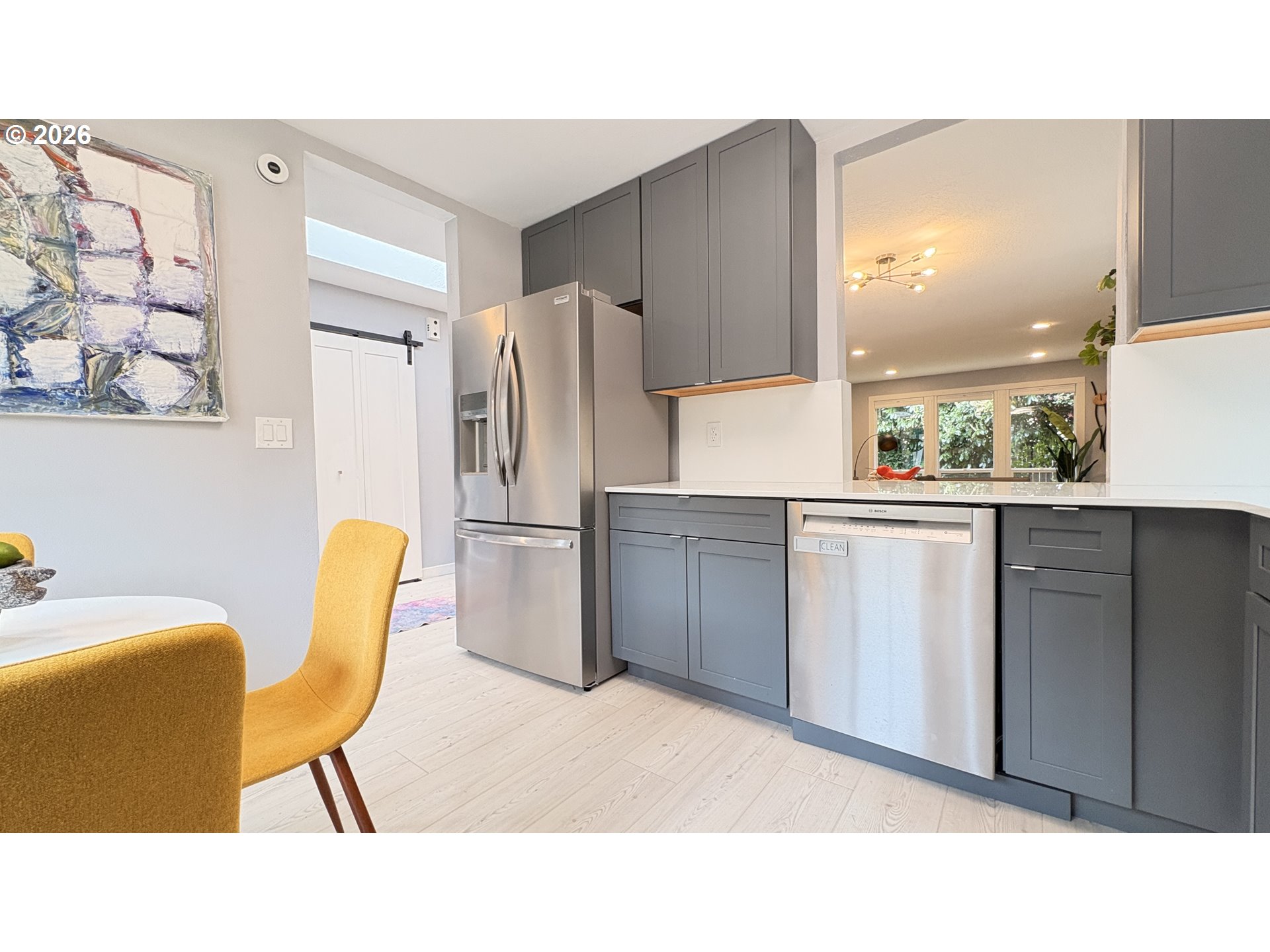 6650 Southwest Canby Street Portland, OR 97223 - Photo 8 of 34 a kitchen with a refrigerator a table chairs and a refrigerator