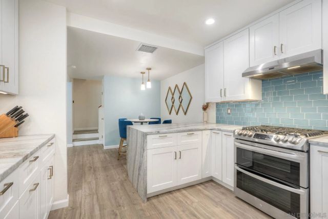 a kitchen with a stove oven and sink