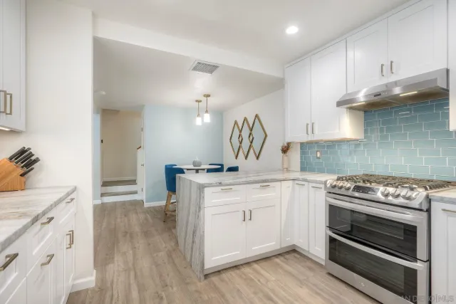 a kitchen with a stove oven and sink