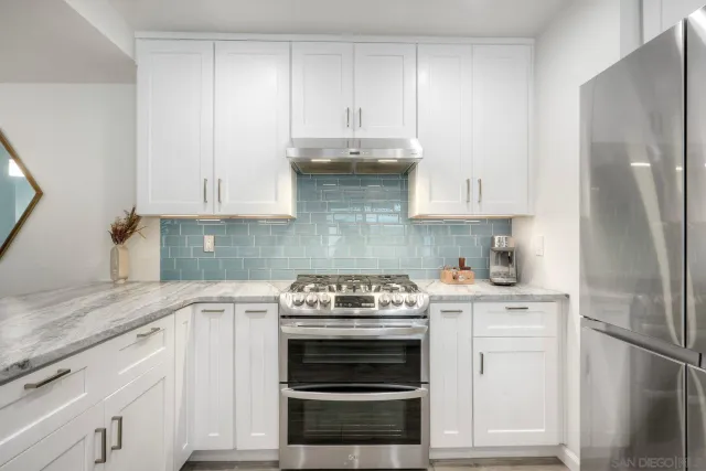 a kitchen with cabinets appliances and a wooden floor