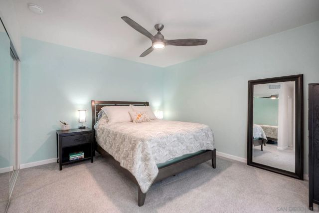 a bedroom with a bed and a mirror