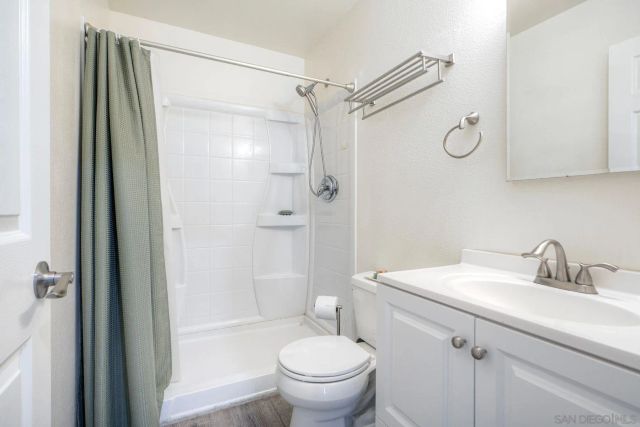 a bathroom with a sink toilet and shower