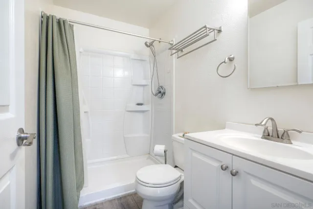 a bathroom with a sink toilet and shower