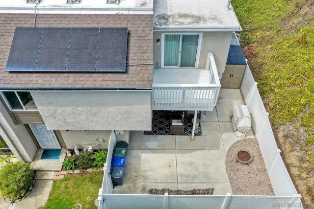 an aerial view of a house with a yard and balcony