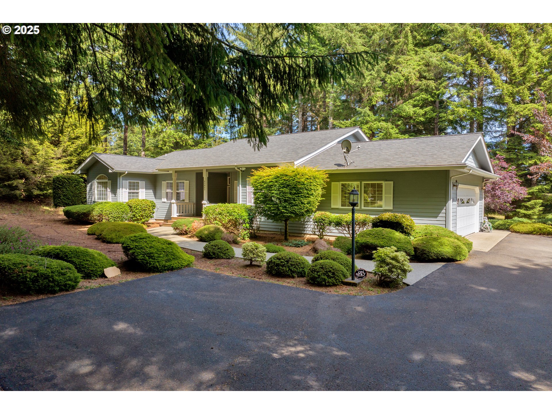 83485 Clear Lake Road Florence, OR 97439 - Photo 4 of 47 a front view of a house with a garden