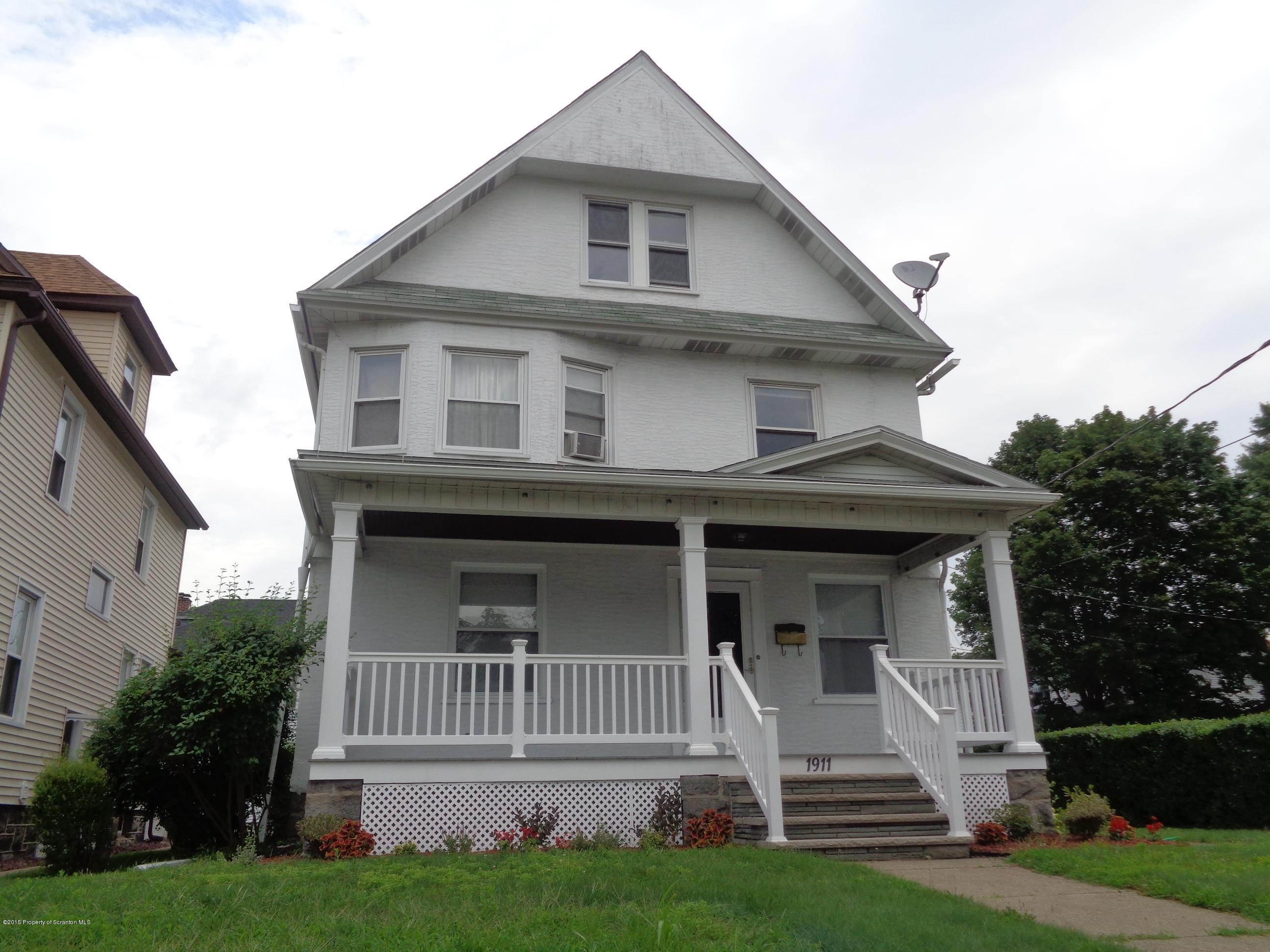 1911 Green Ridge Street Dunmore, PA 18512 - Photo 1 of 16 a front view of a house with a garden