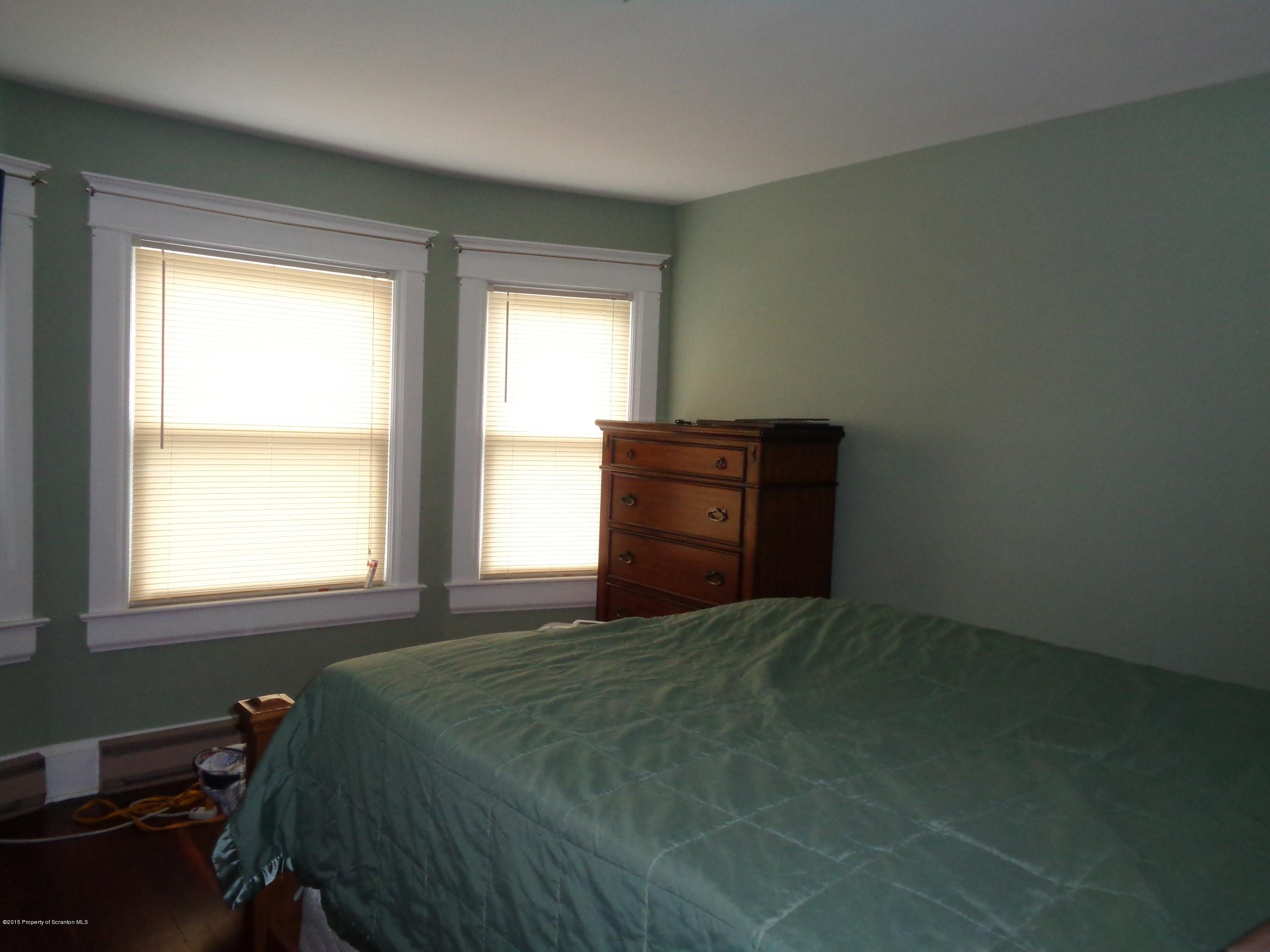 1911 Green Ridge Street Dunmore, PA 18512 - Photo 11 of 16 a bed sitting in a bedroom next to a window