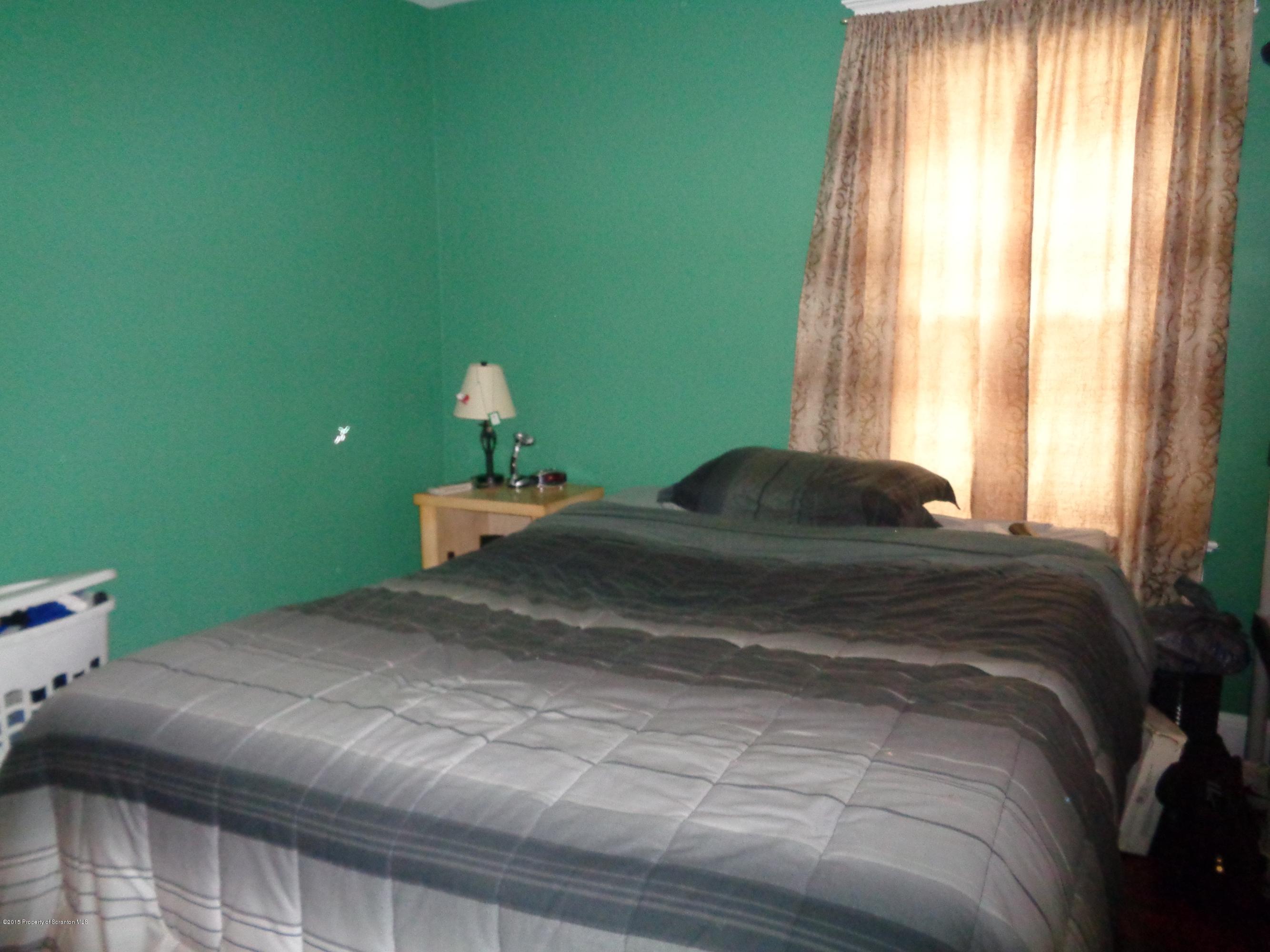 1911 Green Ridge Street Dunmore, PA 18512 - Photo 12 of 16 a bedroom with a bed and a window