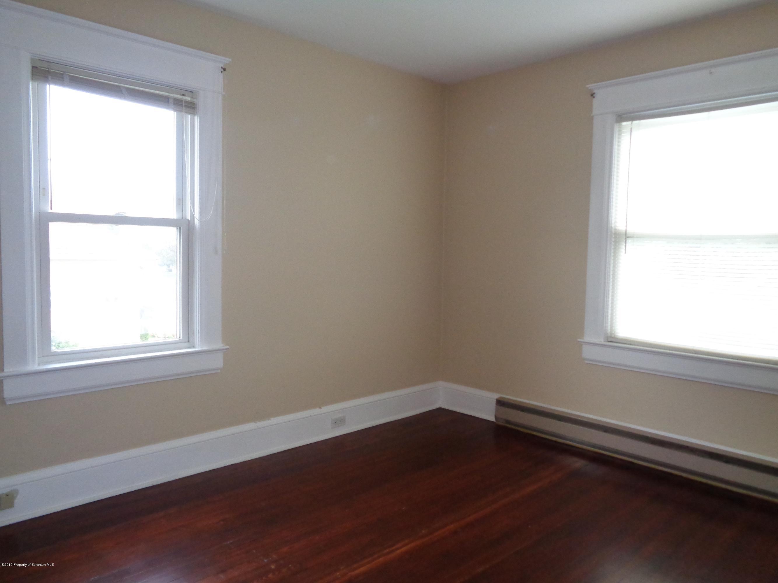 1911 Green Ridge Street Dunmore, PA 18512 - Photo 14 of 16 an empty room with wooden floor and a window