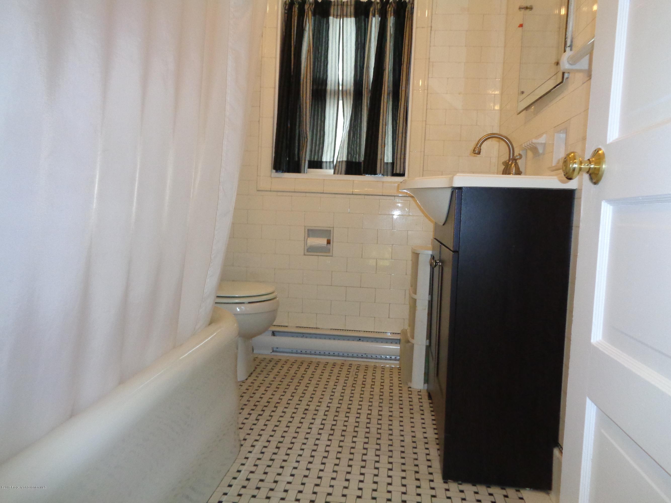 1911 Green Ridge Street Dunmore, PA 18512 - Photo 15 of 16 a bathroom with a sink and a toilet