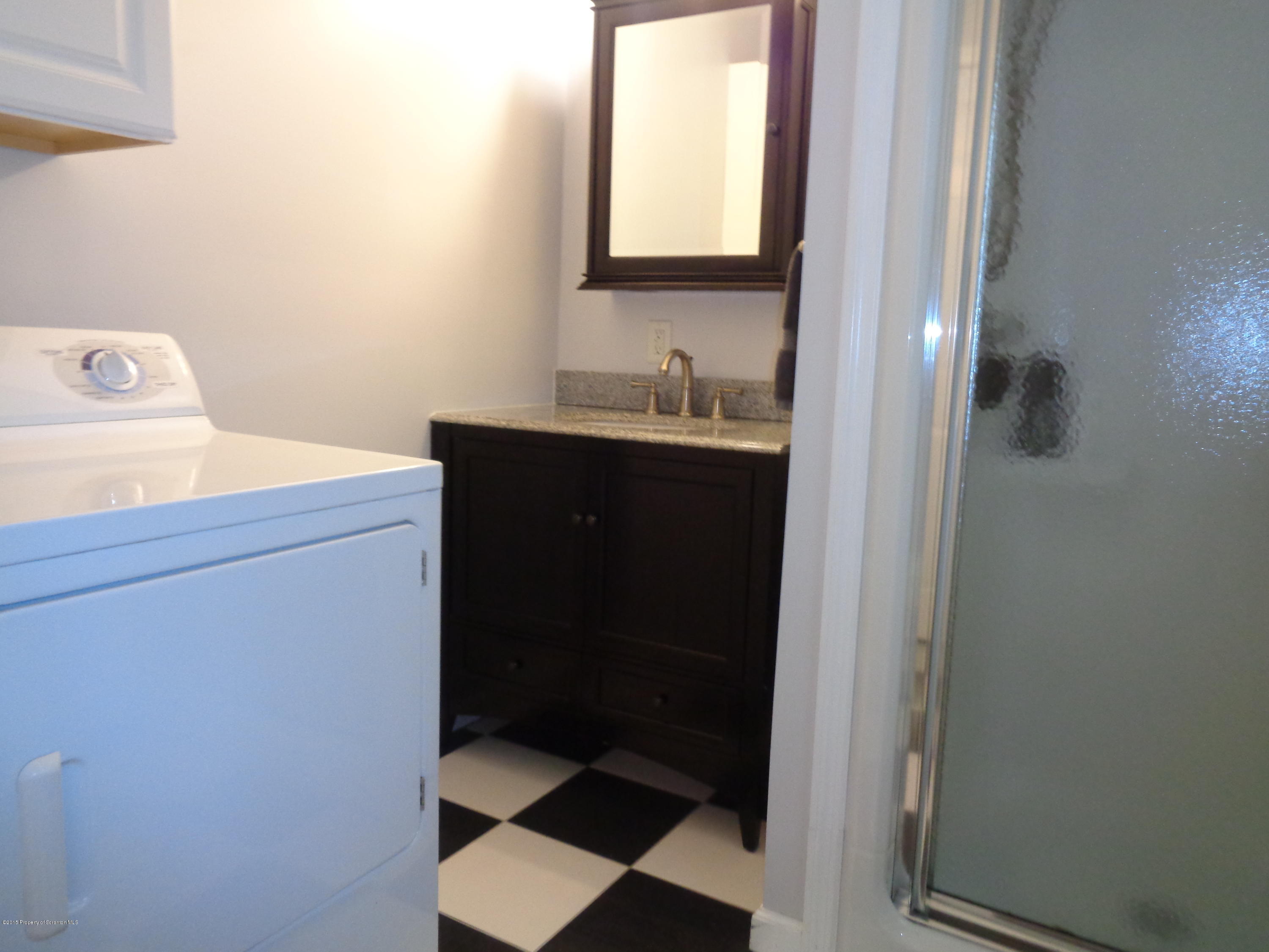 1911 Green Ridge Street Dunmore, PA 18512 - Photo 16 of 16 a bathroom with a sink and a mirror