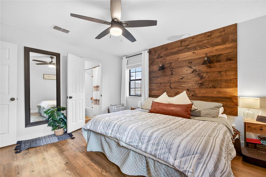 703 College Street Celeste, TX 75423 - Photo 15 of 29 a bedroom with a bed lamp and wooden floor