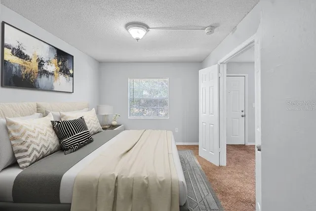 a bedroom with a large bed and a window