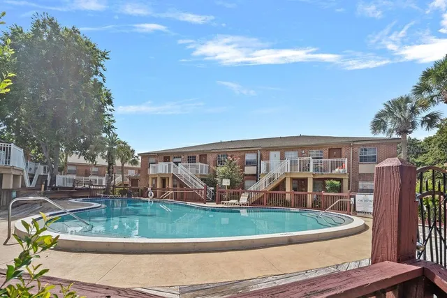 a view of a backyard with wooden fence
