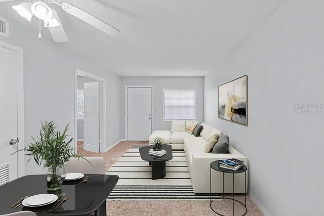 a living room with furniture potted plant and a chandelier