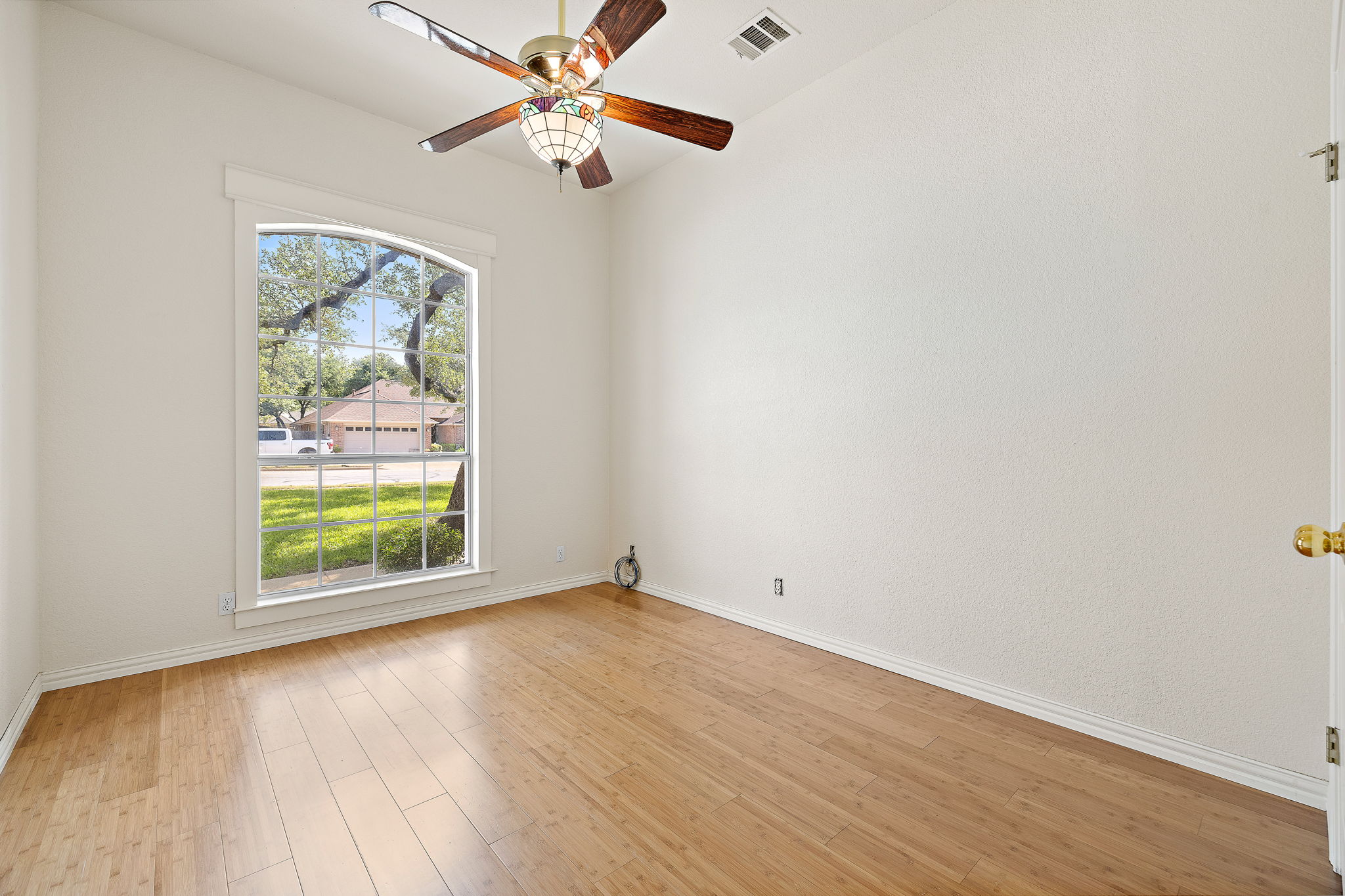 1102 Nelson Ranch Road Cedar Park, TX 78613 - Photo 27 of 37 A graceful arched window overlooks the street, illuminating this bright, inviting space with rich wood flooring.