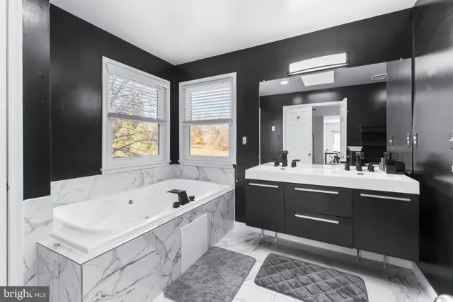 a spacious bedroom with a bed and a chandelier