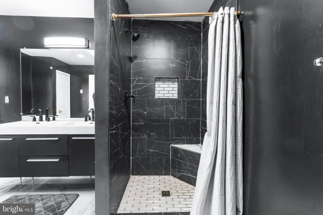 a utility room with dryer washer and a view of living room