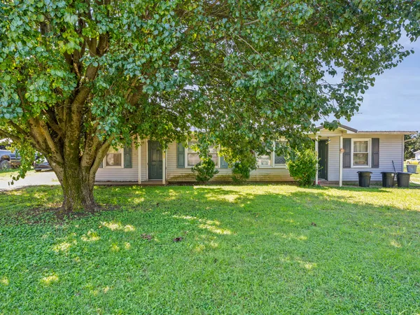 a view of a house with a backyard