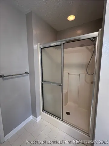 a bathroom with a glass shower door