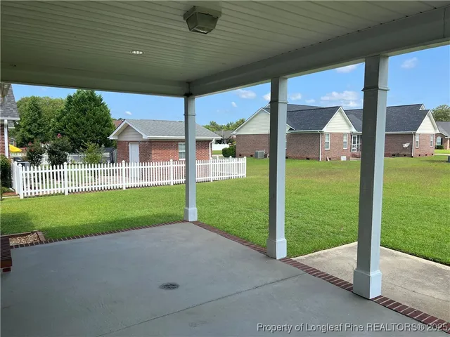 a view of a house with backyard and porch