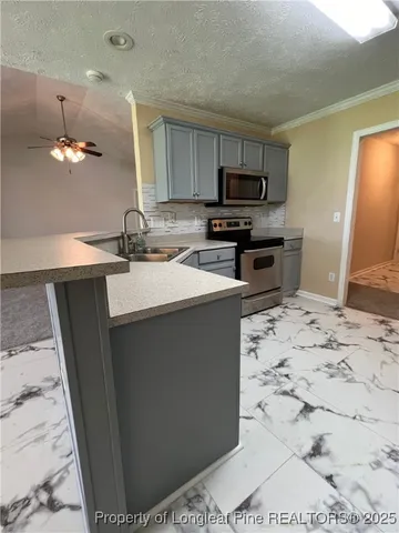 a kitchen with a sink appliances and cabinets