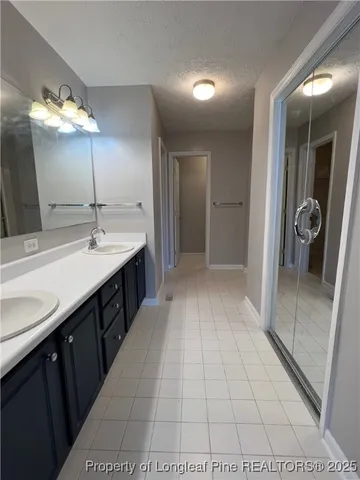 a spacious bathroom with a sink and a mirror
