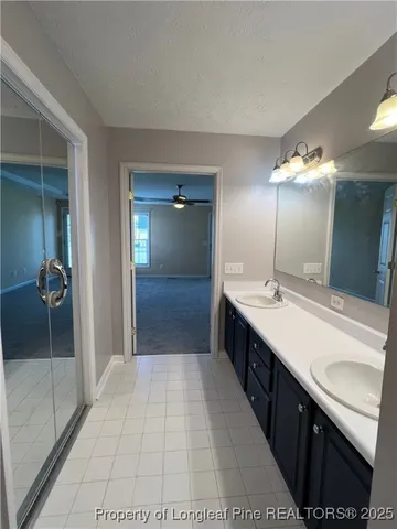 a large bathroom with a double vanity sink and a mirror