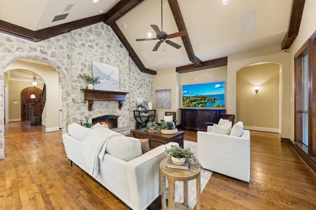 a living room with furniture a fireplace and a flat screen tv