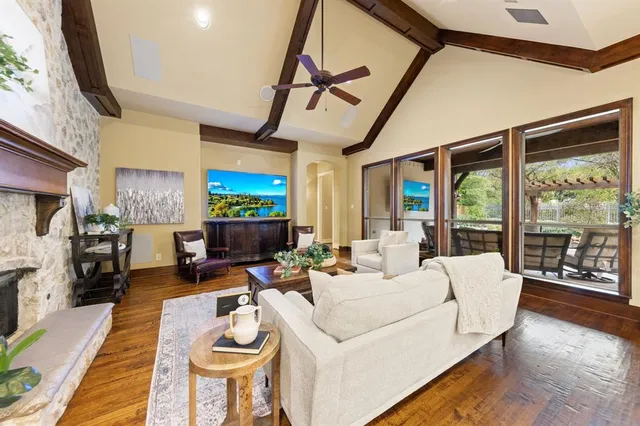 a living room with fireplace furniture and a large window