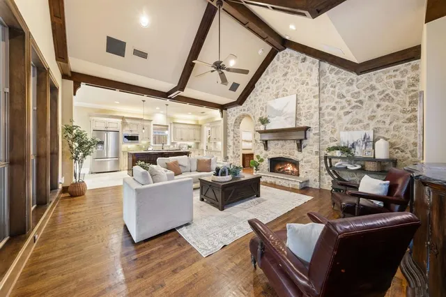 a living room with furniture fireplace and flat screen tv