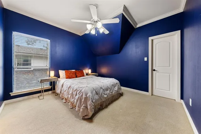 a bed sitting in a room next to a window