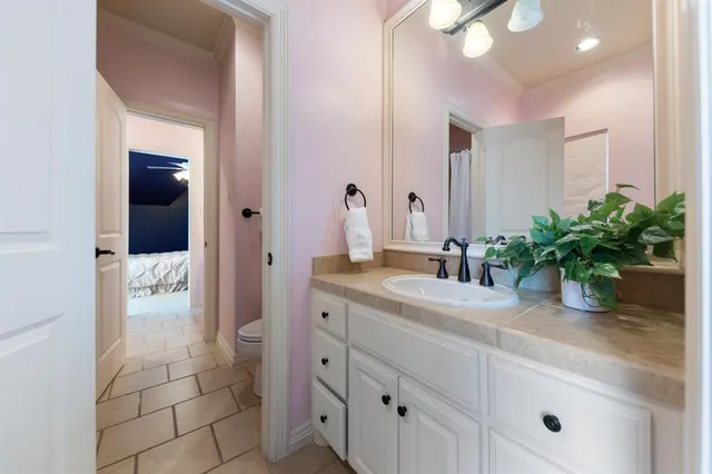a bathroom with a granite countertop sink a mirror and a shower