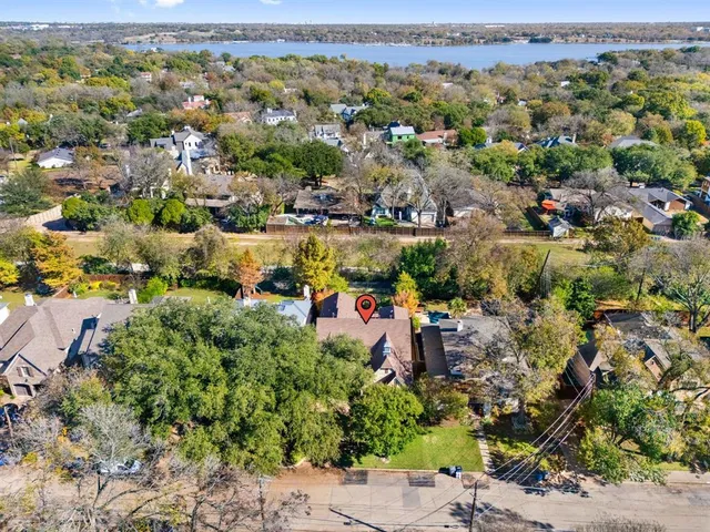 an aerial view of a houses with a lake view