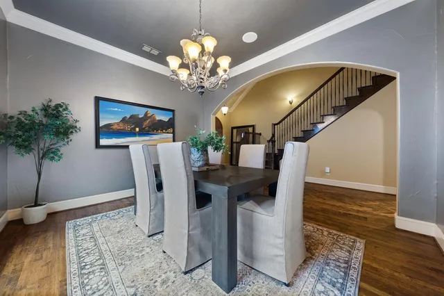 a view of a dining room with furniture and chandelier
