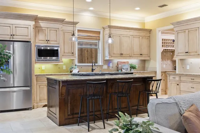 a kitchen with a refrigerator and a stove top oven