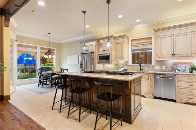 a kitchen with a table chairs stove and cabinets