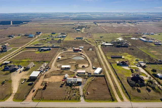 a living room with furniture a flat screen tv and a window