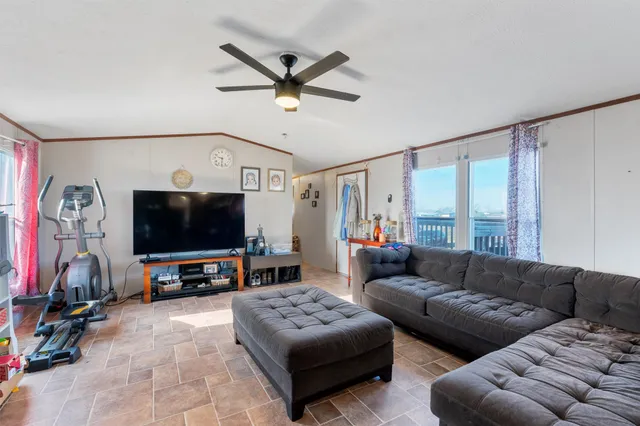 a view of a dining room with furniture and a chandelier