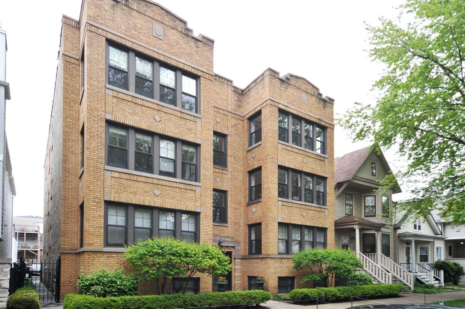 3933 North Marshfield Avenue, Unit 2S Chicago, IL 60613 - Photo 1 of 17 a front view of a residential apartment building with a yard