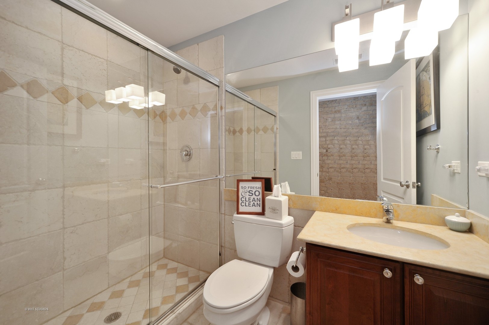 3933 North Marshfield Avenue, Unit 2S Chicago, IL 60613 - Photo 15 of 17 a bathroom with a sink a toilet and shower