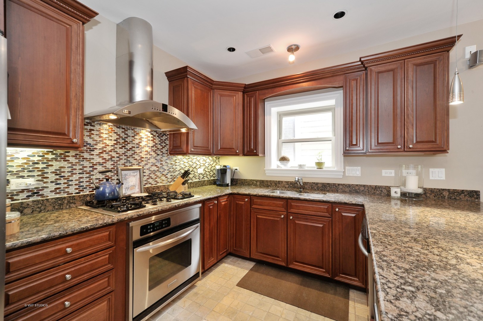 3933 North Marshfield Avenue, Unit 2S Chicago, IL 60613 - Photo 6 of 17 a kitchen with stainless steel appliances granite countertop wooden cabinets a sink and dishwasher