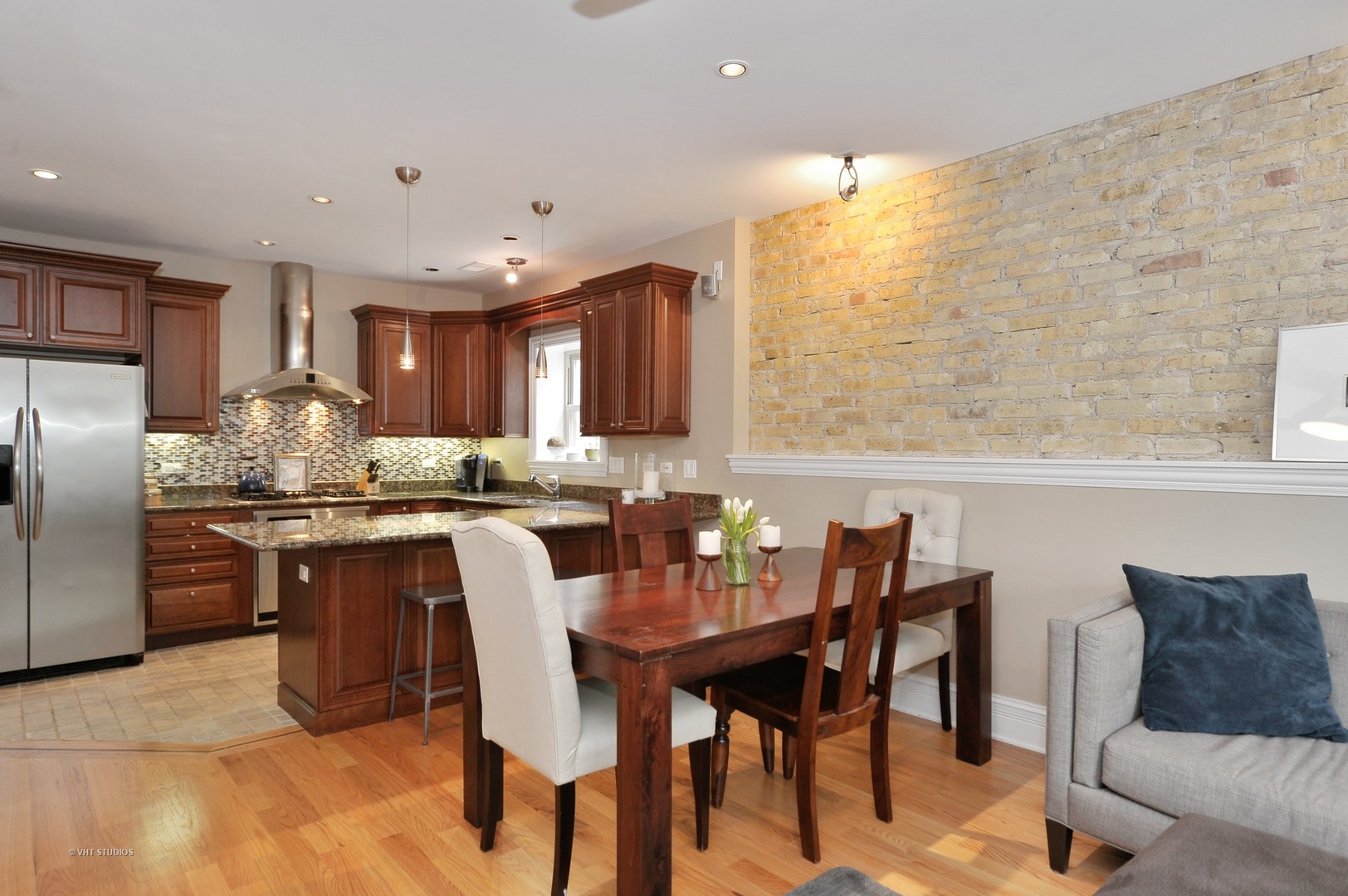 3933 North Marshfield Avenue, Unit 2S Chicago, IL 60613 - Photo 8 of 17 a kitchen with granite countertop a table chairs microwave and cabinets