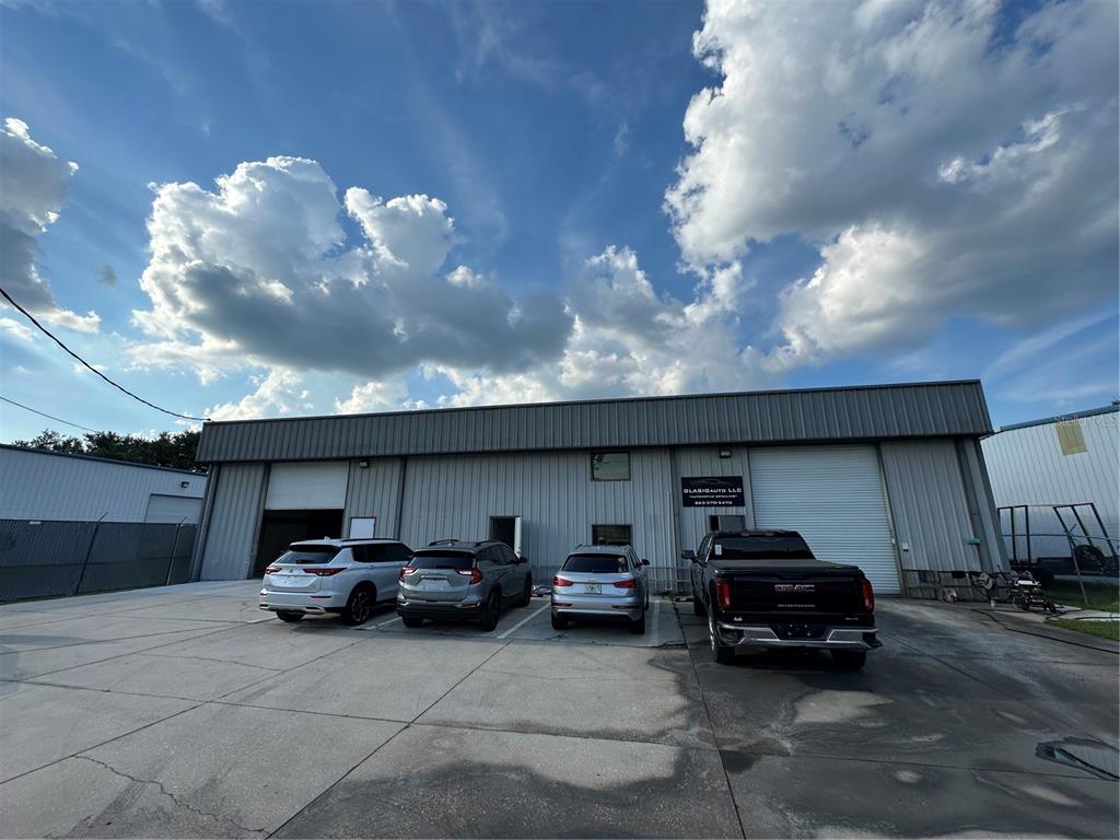 4459 Holden Road Lakeland, FL 33811 - Photo 2 of 27 a car parked in parking area of a building